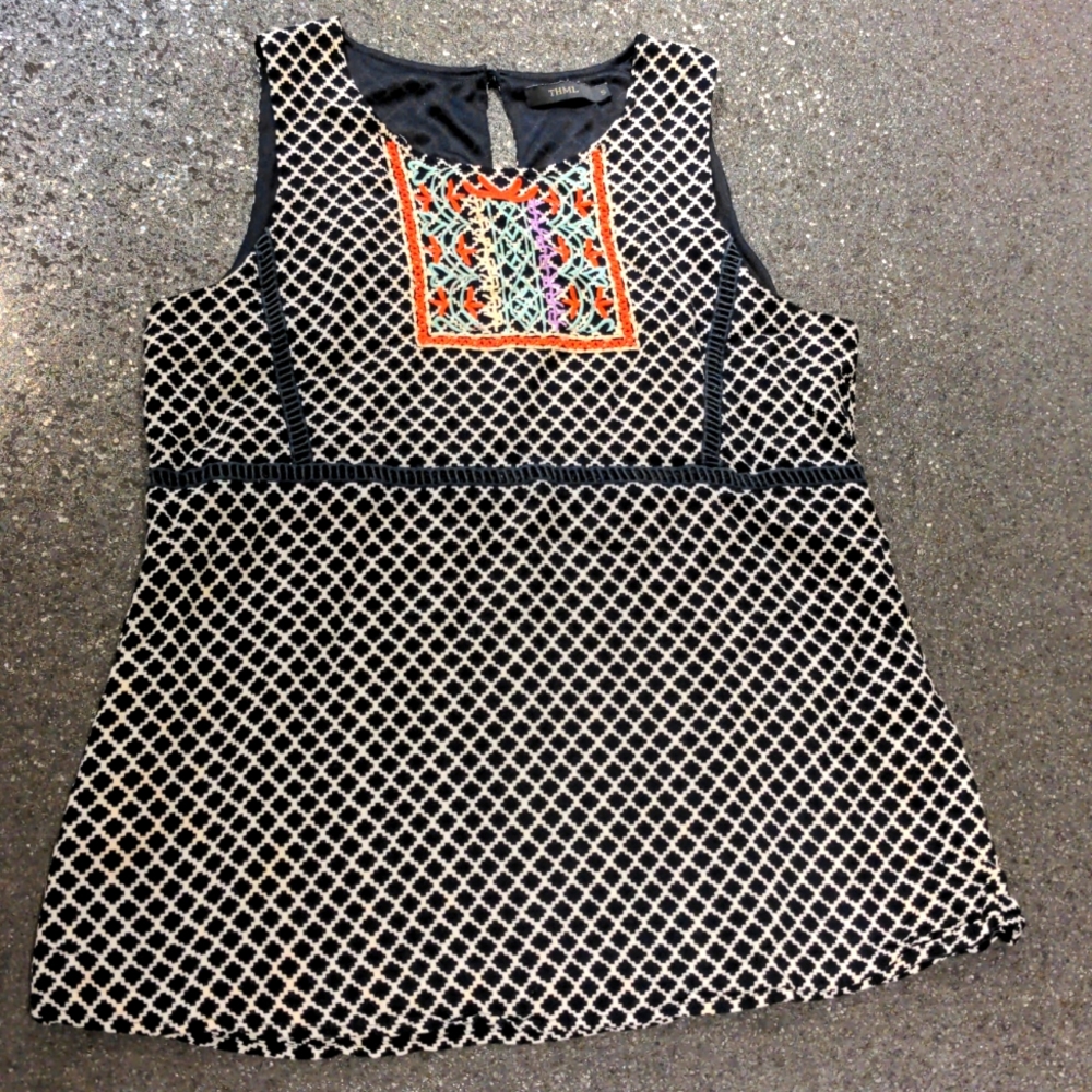 Sleeveless blouse with embroidered detail.